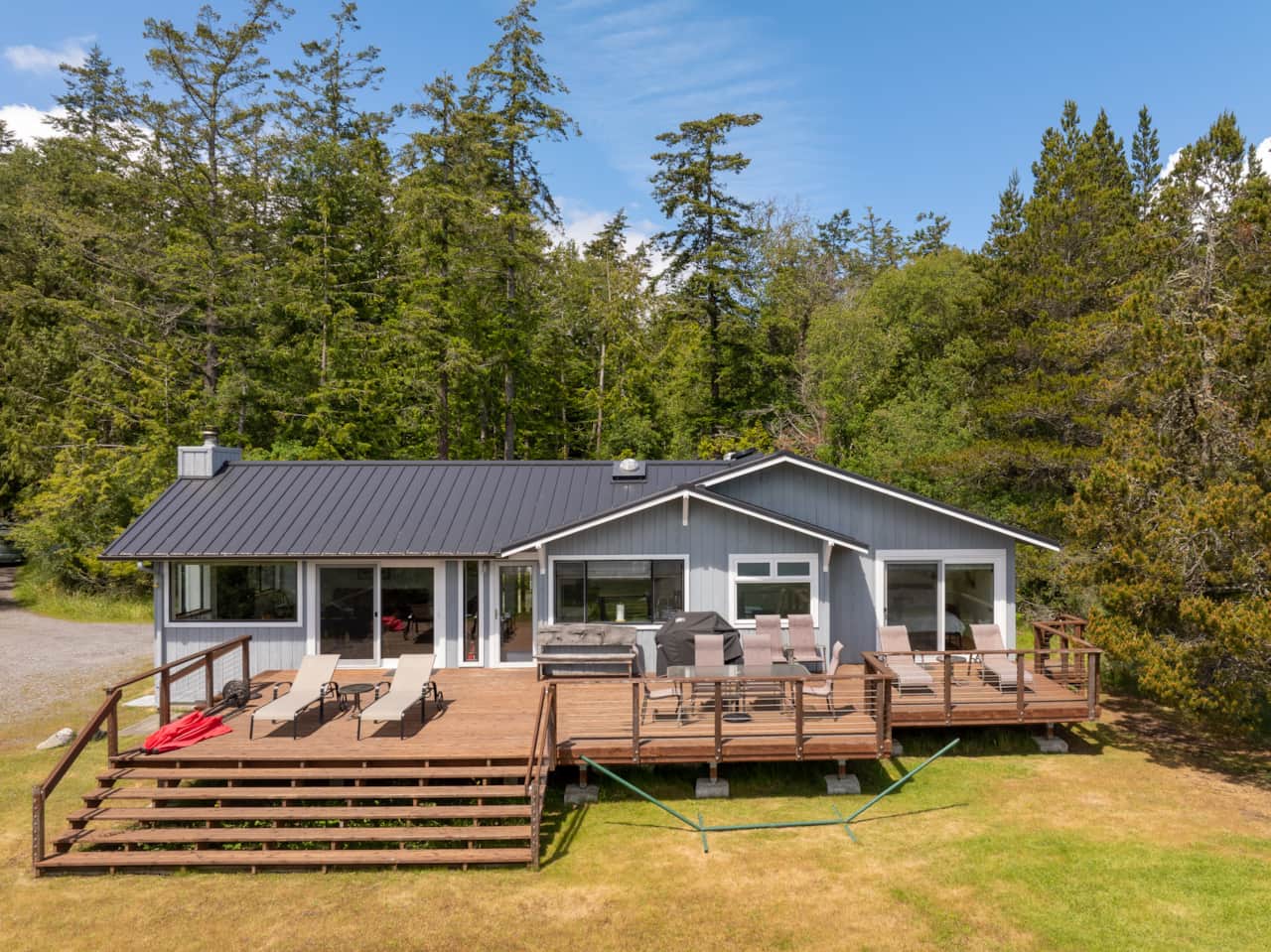 The house from the lawn. The deck runs the full length of the house.