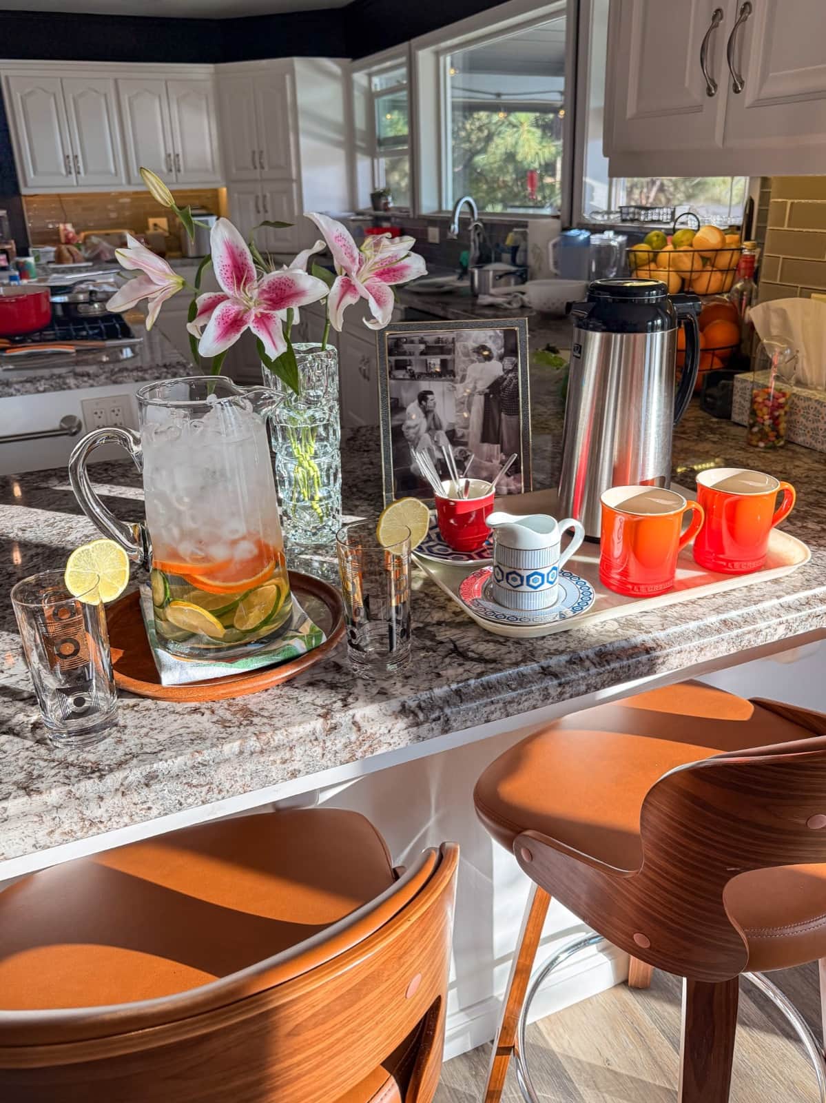 Orange coffee mugs beside the guest coffee and water bar at Mountain Daddies