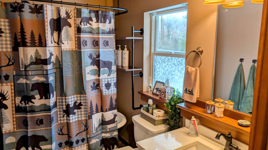 Downstairs bath features a claw-foot tub