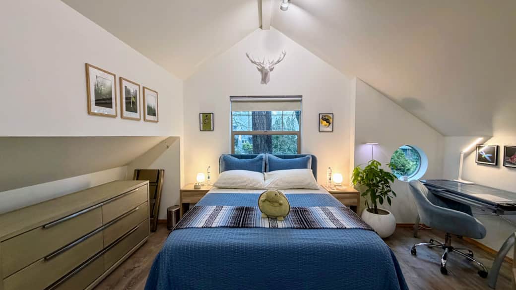 Bedroom includes a queen bed and sofa bed, dedicated workspace, 40” Roku TV, and ample storage.