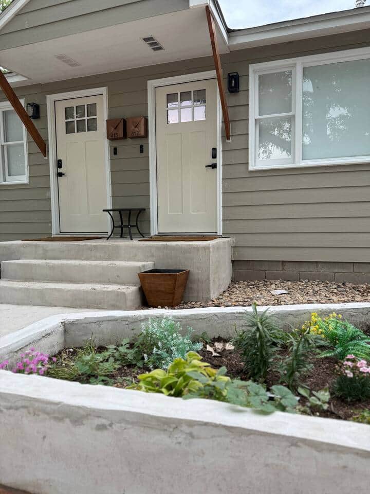 Your cozy retreat starts right at the front steps, complete with cheerful blooms and a shared porch.