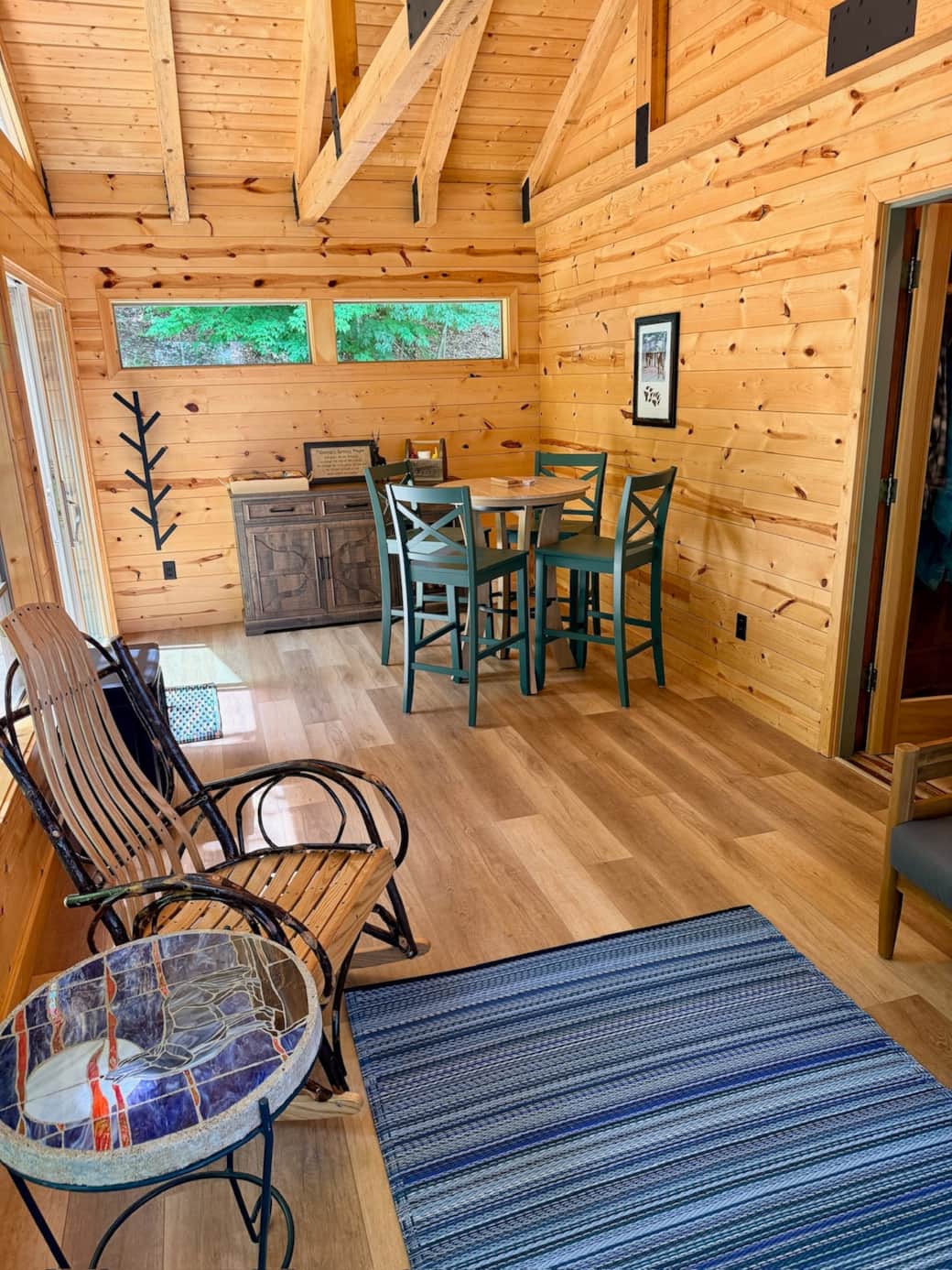 Gather for games after a day outdoor or simply enjoy the quiet from the sunroom as loons call across the lake. The room includes an electric fireplace stove heater for those cool nights and a sidebar with mini fridge for your beverages.