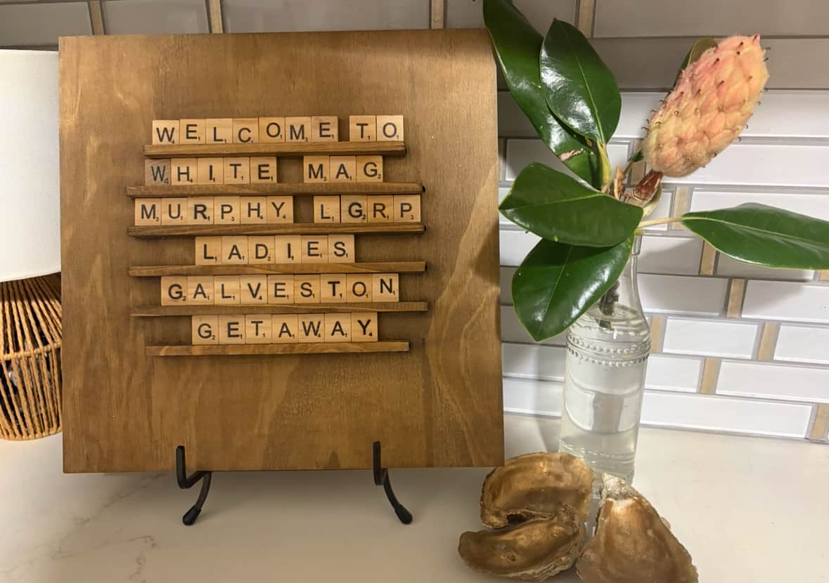 Scrabble tile message board styled in a vacation rental entryway with a custom thank you message