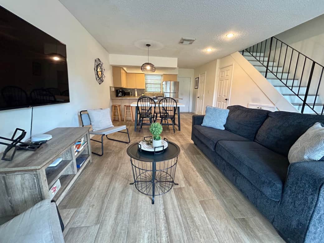 1st Floor - Living Room, Screened in Patio, back yard and Salt Water Lagoon to the left in the back. 1st Floor - Living Room, Screened in Patio, back yard and Salt Water Lagoon to the left in the back.