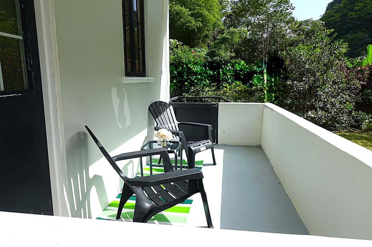 3. Relaxing private balcony at Garden View Apartments with views of the Roseau Valley mountains.