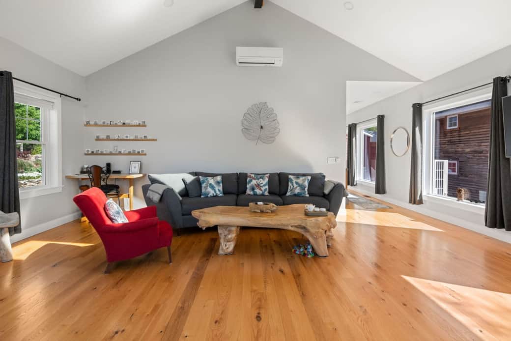 Locally milled hardwood floors throughout with a large teak coffee table as a center piece. Locally milled hardwood floors throughout with a large teak coffee table as a center piece.