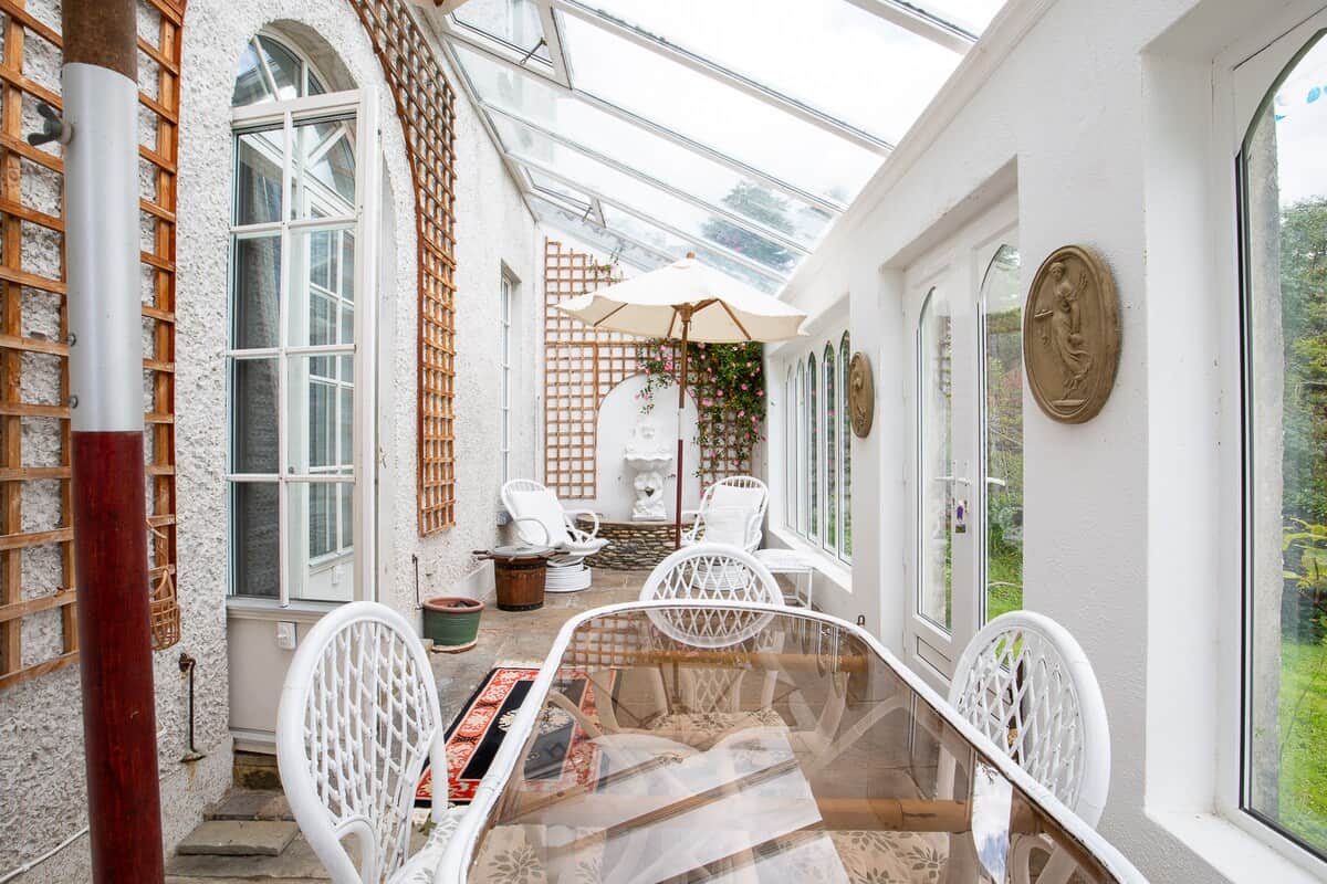 A bright conservatory overlooking the garden has a fountain and comfortable easy-chairs for relaxing in.