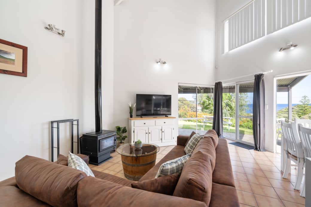 Lounge room with fireplace and ocean views Lounge room with fireplace and ocean views