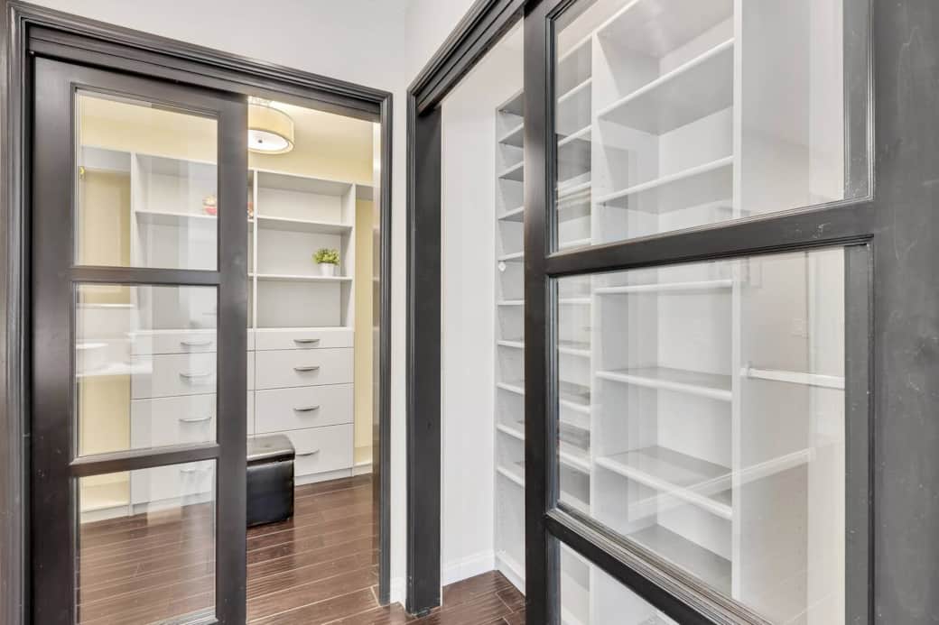 Glass-door closet with built-in storage for tidy, easy organization.