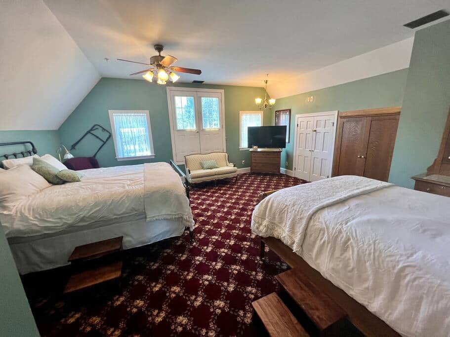  There are two recliners, a love seat and a Smart TV. 
