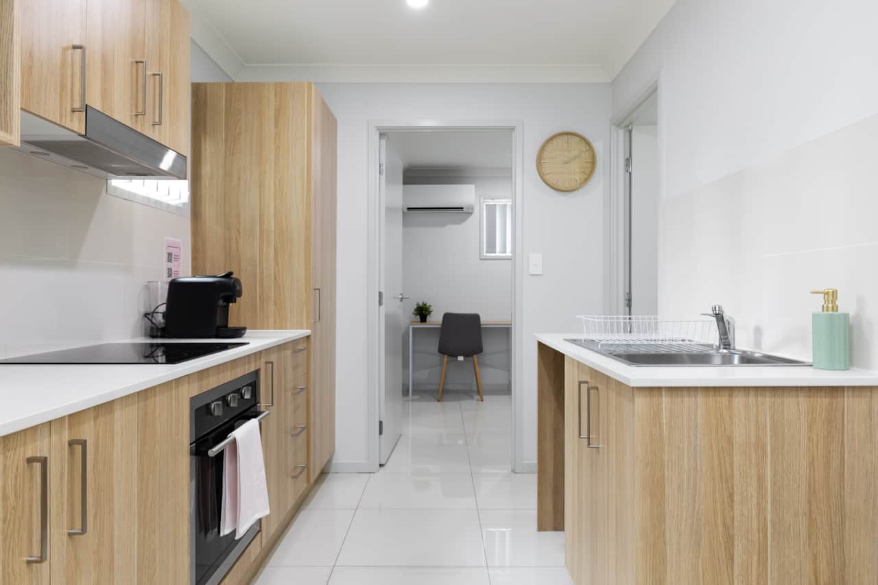 Kitchen: Sleek kitchen with ample storage, modern appliances 