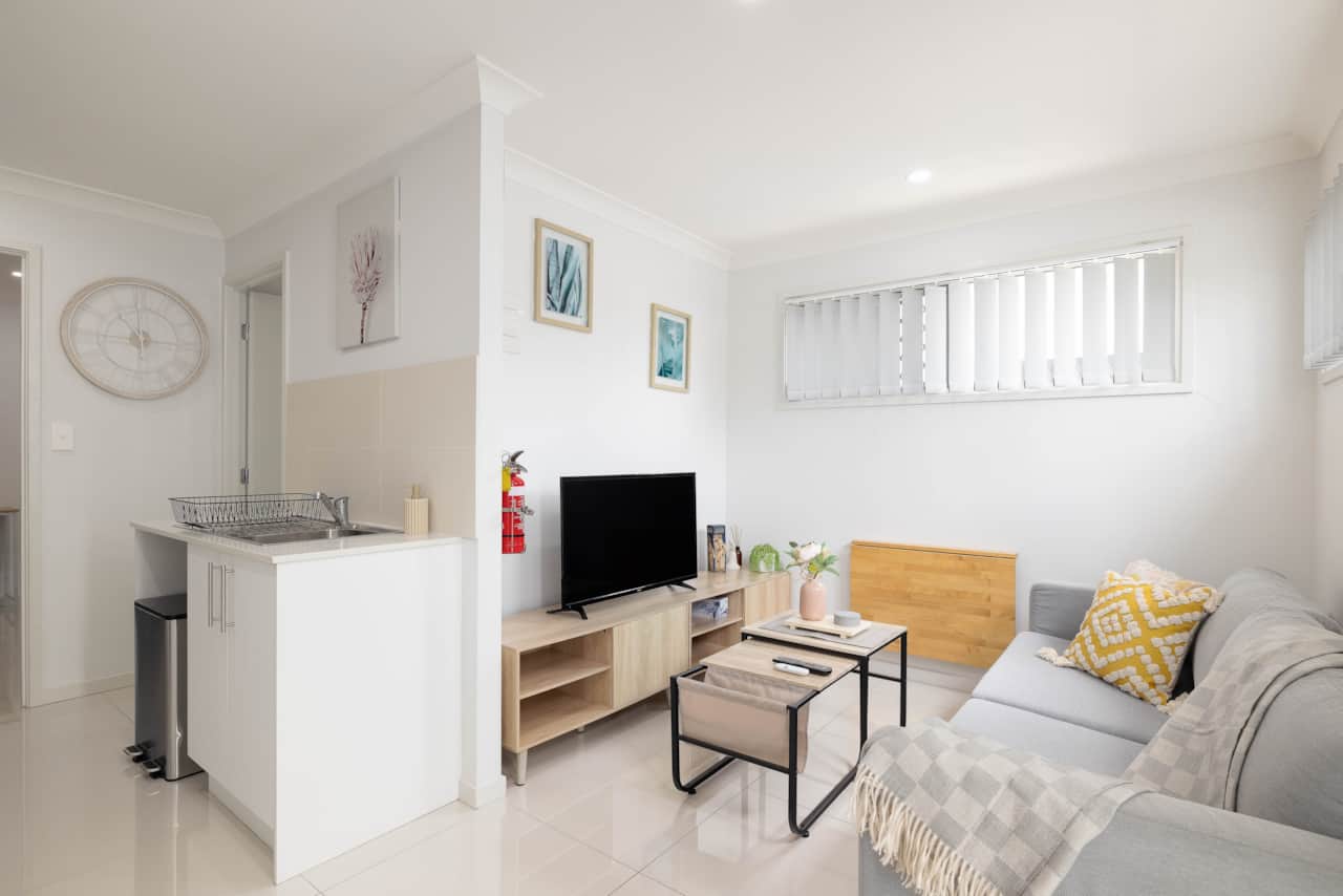Living Area: Bright living space with comfortable seating and TV 