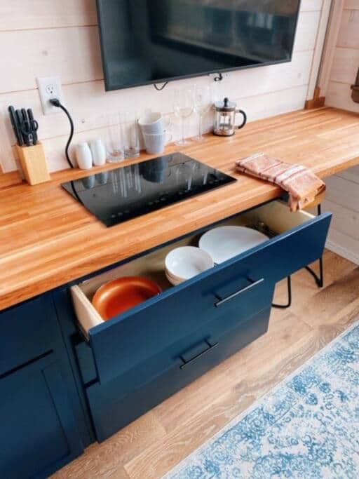 Cooktop, tabletop convection oven, sink and a fridge to keep you fed.
