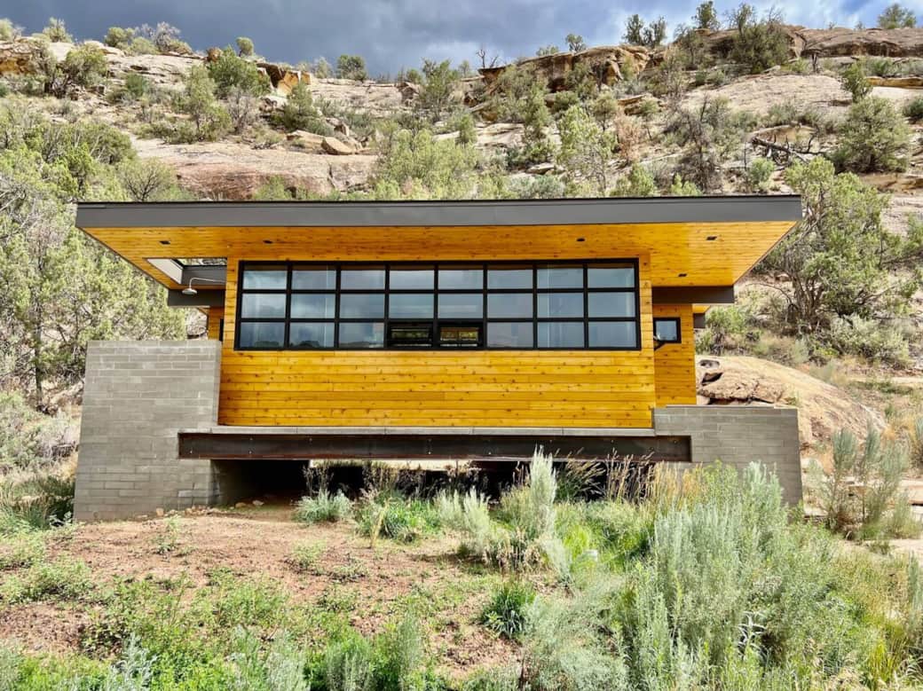 Modern luxury meets the wild. A private spa structure with floor-to-ceiling canyon views