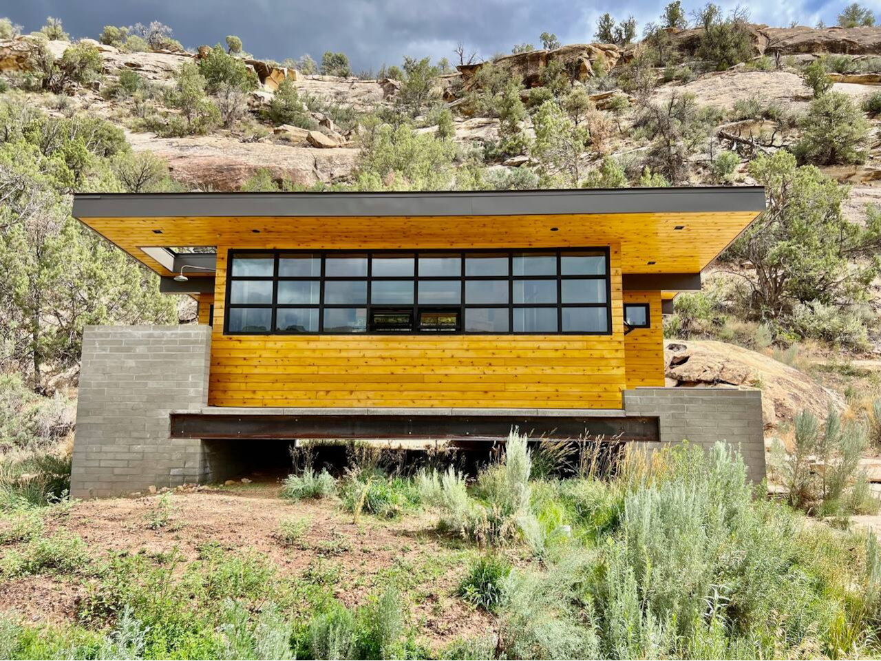 Modern luxury meets the wild. A private spa structure with floor-to-ceiling canyon views