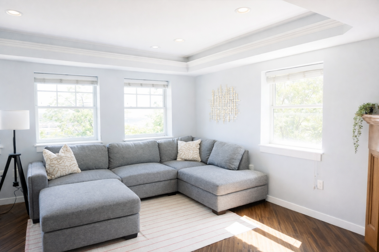 A bright, airy living room with beautiful natural light and a comfortable couch for lounging 