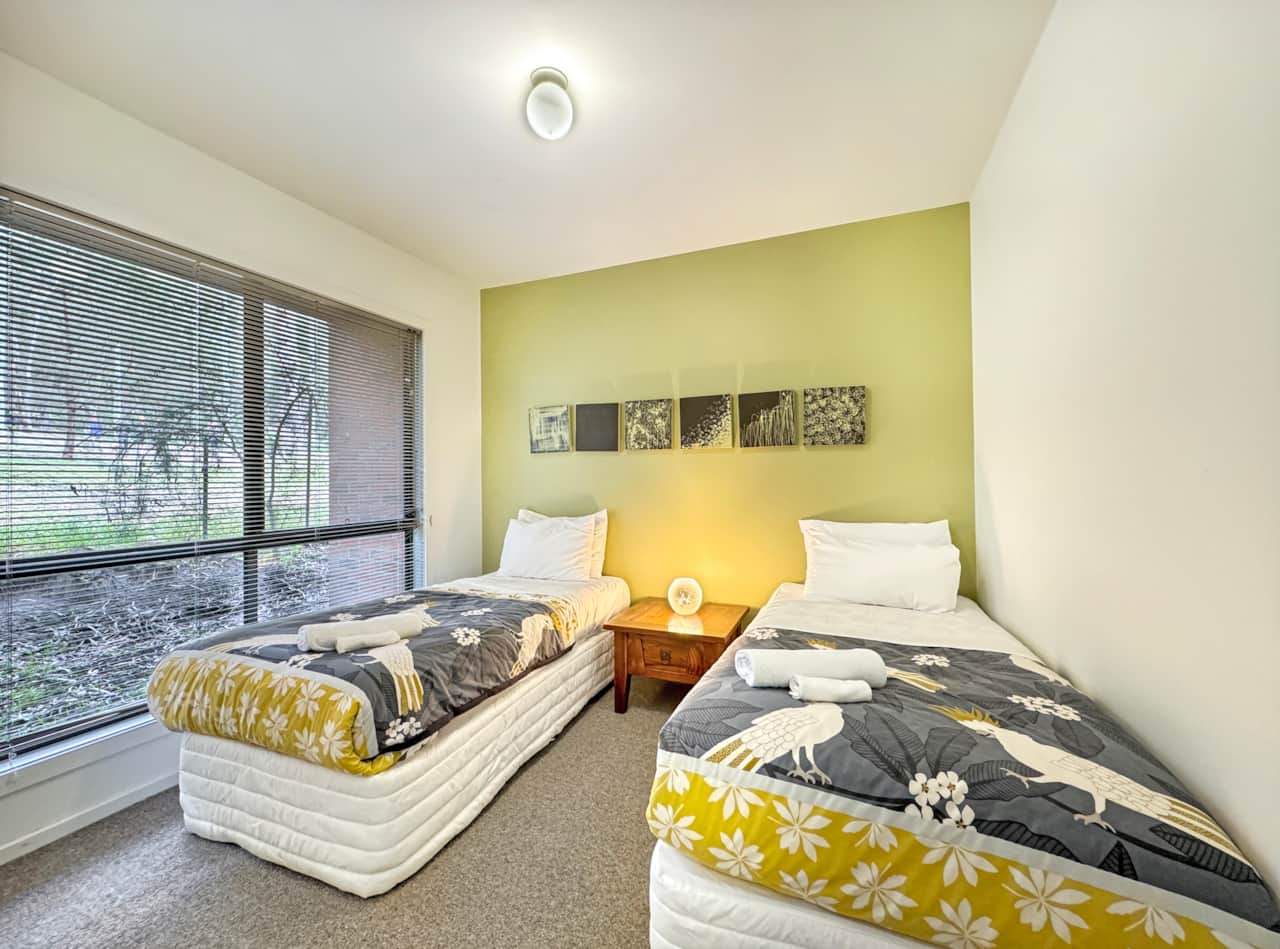 Bedroom 3, situated downstairs, offers two single beds for comfortable accommodation.