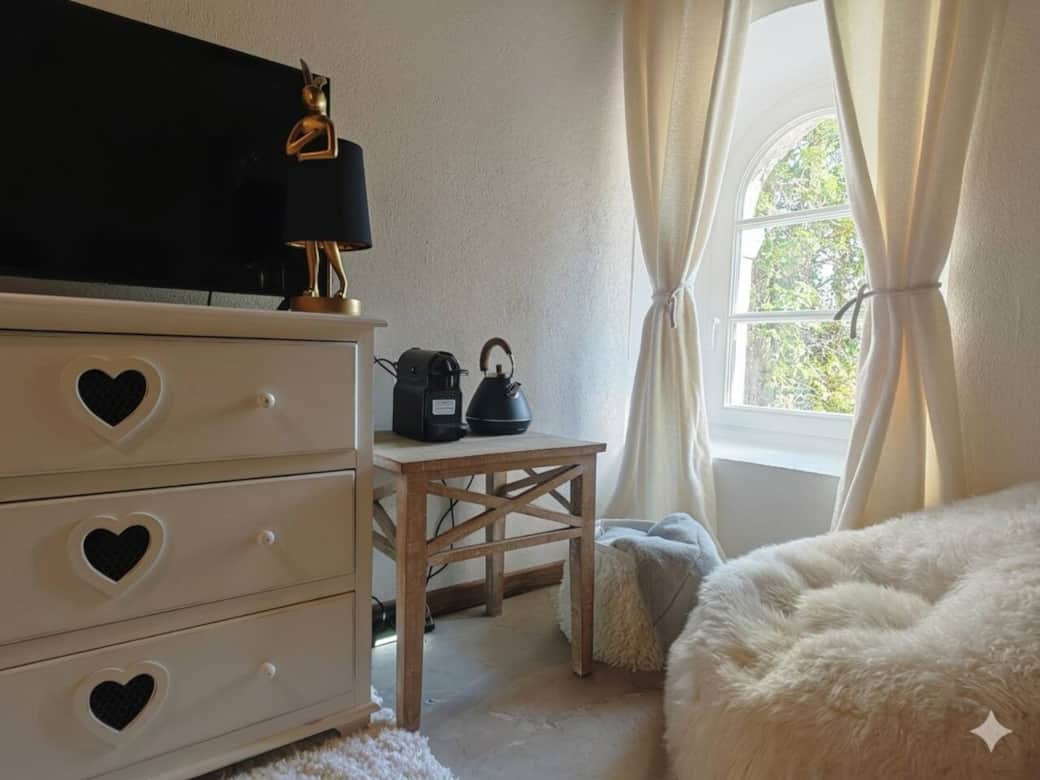 Reading nook by the window with coffee and tea setup overlooking the estate