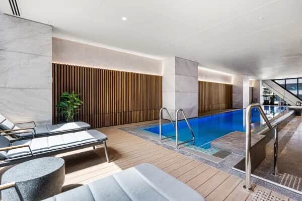 Guests have access to a modern indoor heated swimming pool, perfect for relaxing or unwinding after a day in the city. The space features comfortable loungers and a clean, contemporary design for a calm and enjoyable experience.