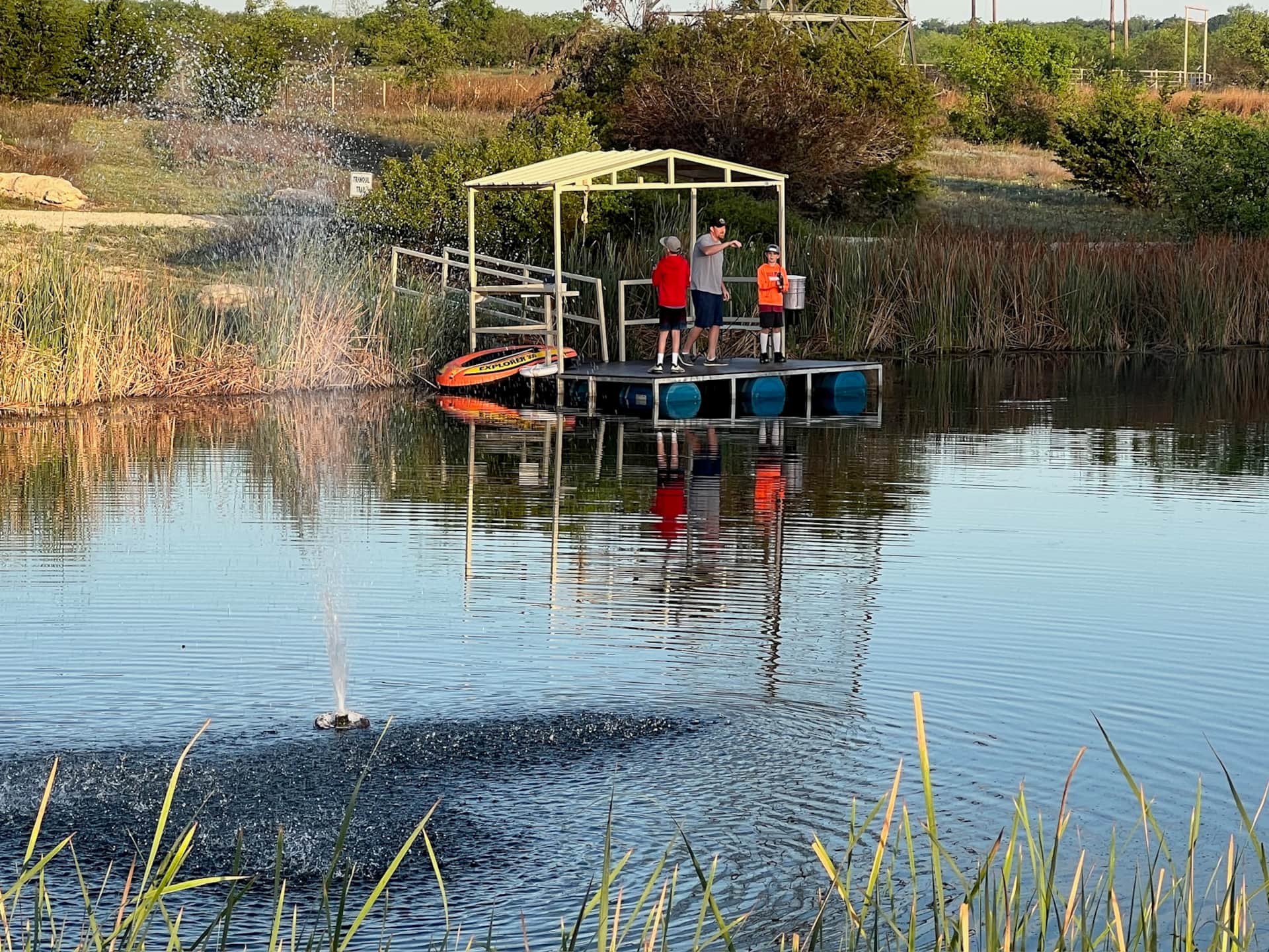 Church family fishing at the beaver pond dock Lake Godstone Graford TX