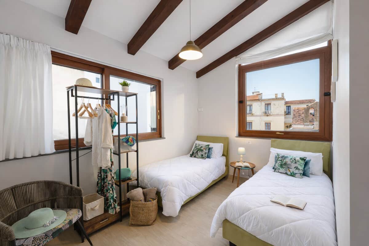 Bright twin bedroom with joinable beds and private terrace access in central Sorrento