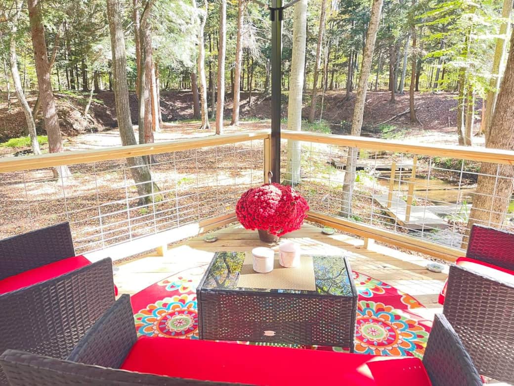 Seating area offers a cozy spot to relax while taking in breathtaking views over the creek