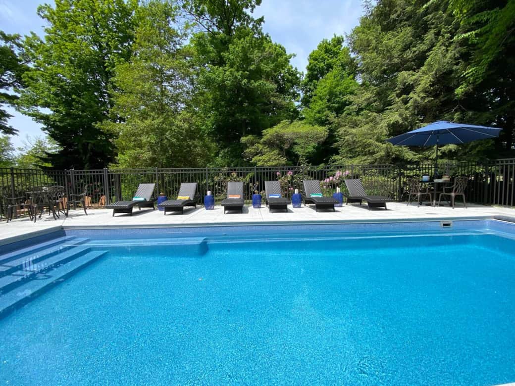 In ground, heated pool with electric cover is located just off the patio.