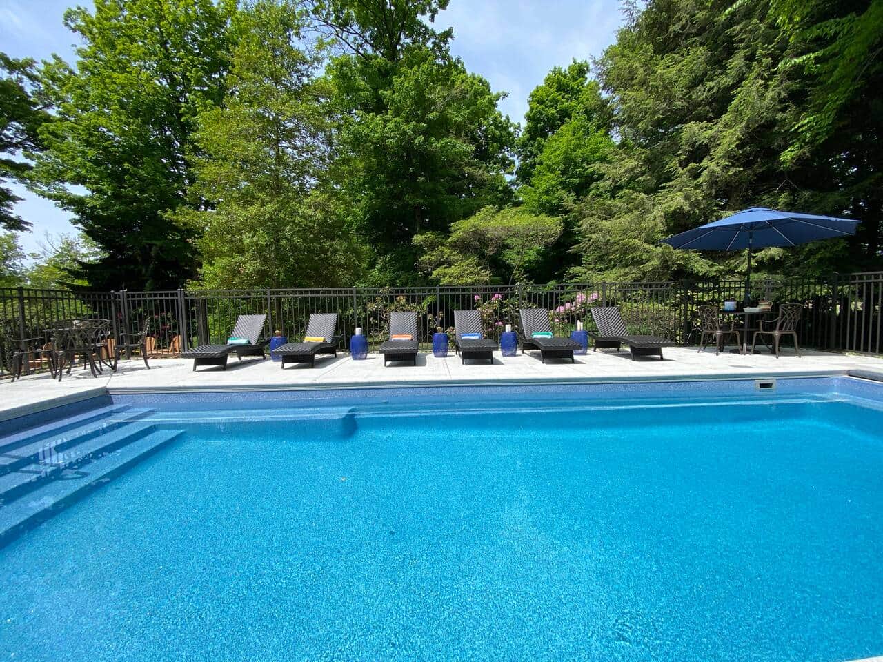 In ground, heated pool with electric cover is located just off the patio.