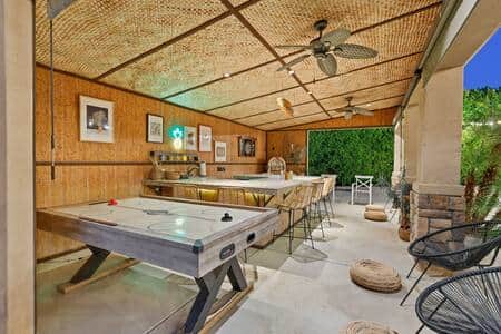 Try your hand at air hockey after some tiki-infused beverages