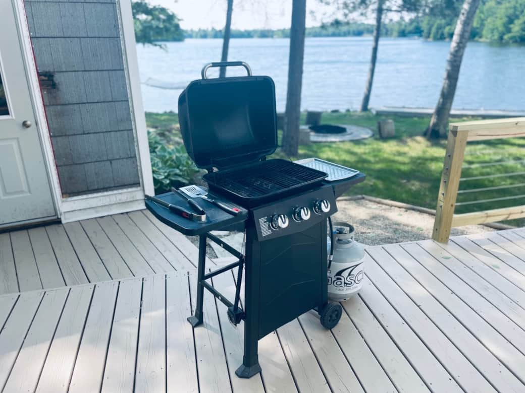 BBQ Grill with utensils and propane tank