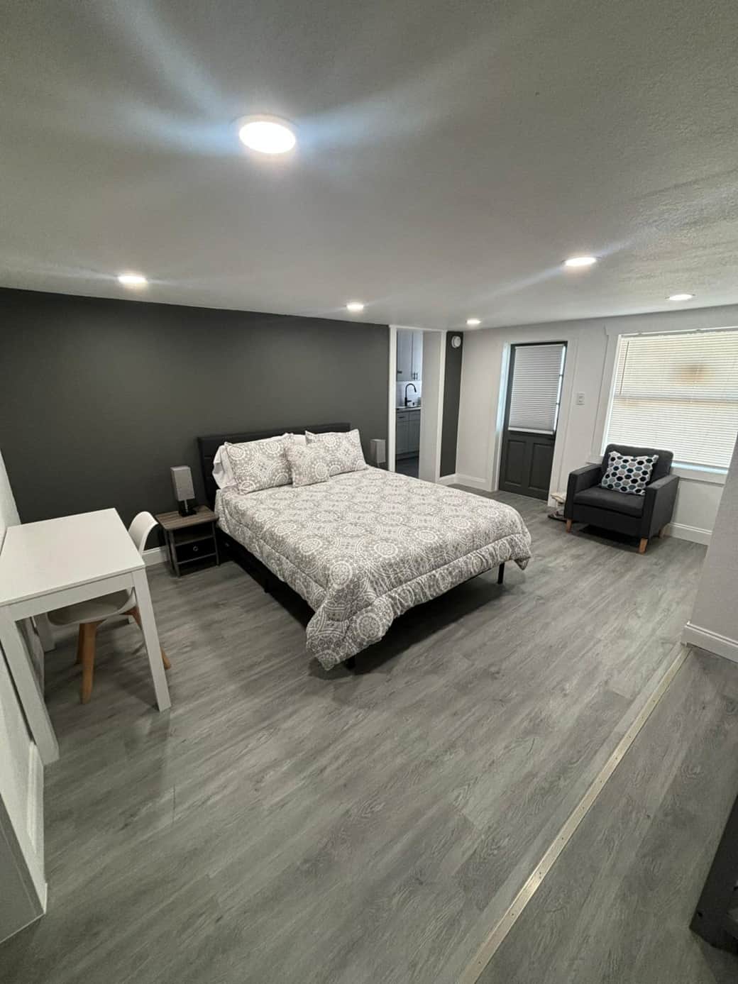 Spacious, well-lit bedroom with a comfortable queen-size bed. Lakeland, FL