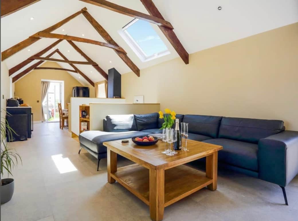 Enjoy a stylish open-plan living area with a fully equipped kitchen and a welcoming log burner.