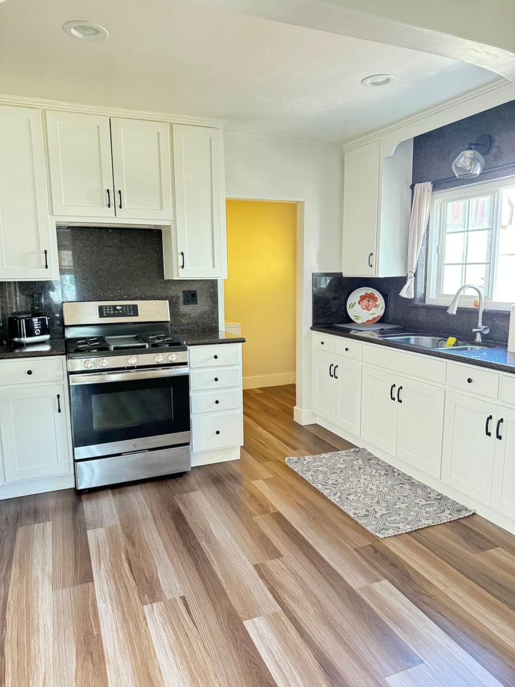 Beautiful spacious kitchen with updated appliances, granite countertops, new appliances, plenty of dishes, pots pans, and cooking essentials.