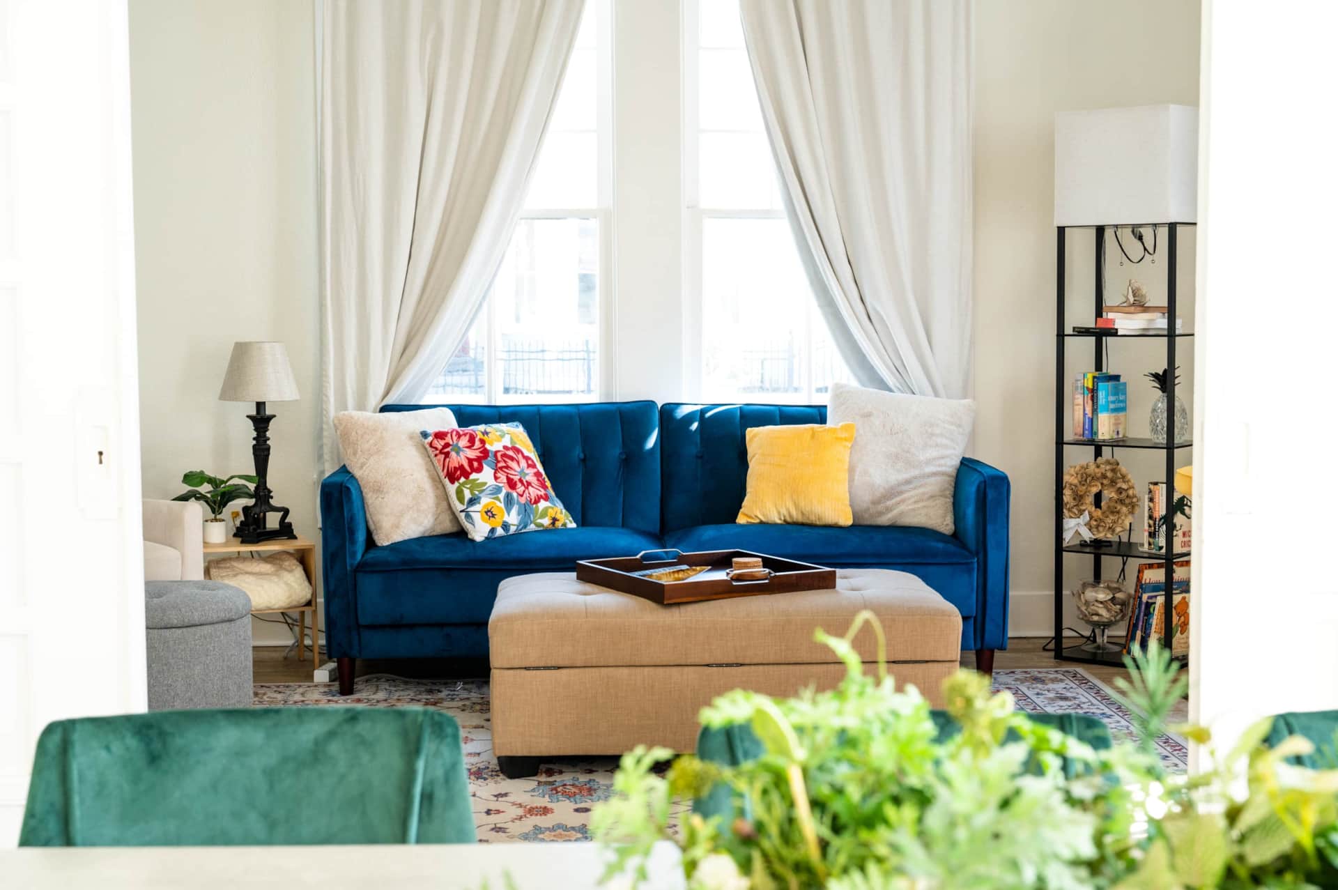 Cozy living room with sleeper sofa, ottoman, and games.