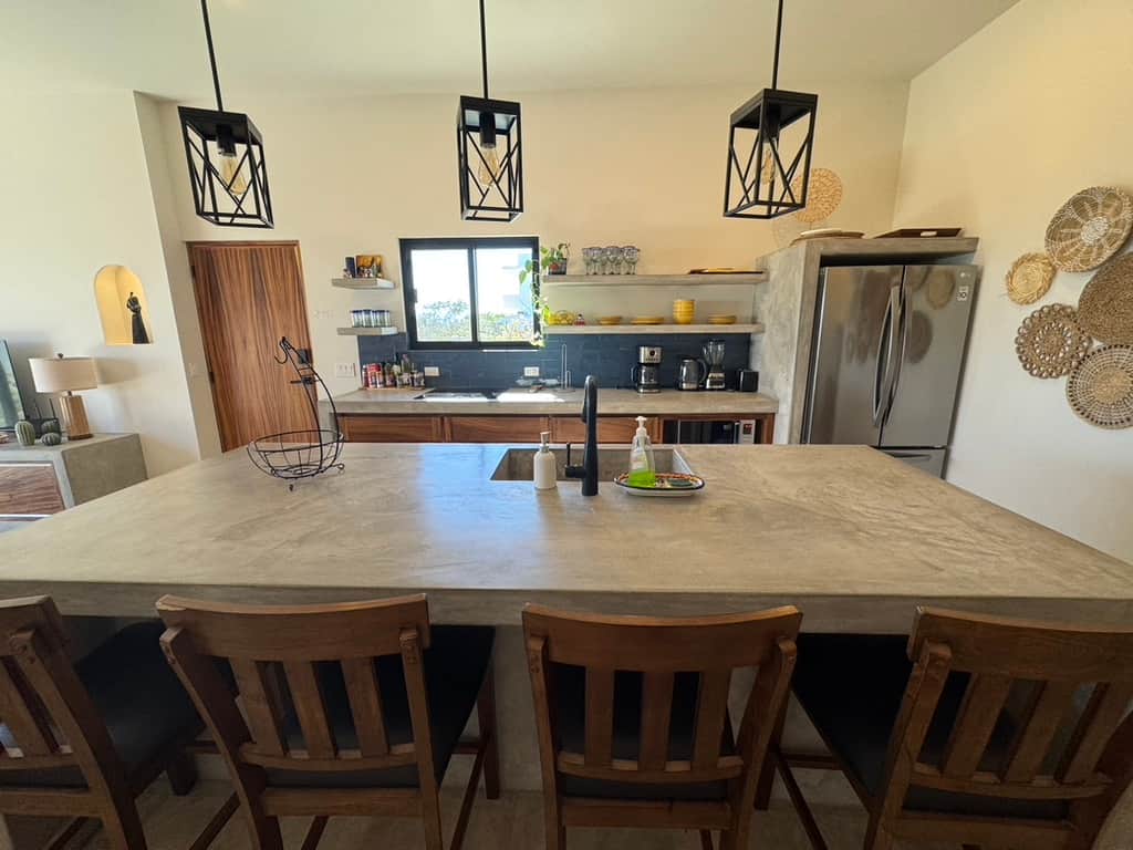 A welcoming kitchen island with four bar stools, perfect for meals, snacks, or mingling A welcoming kitchen island with four bar stools, perfect for meals, snacks, or mingling