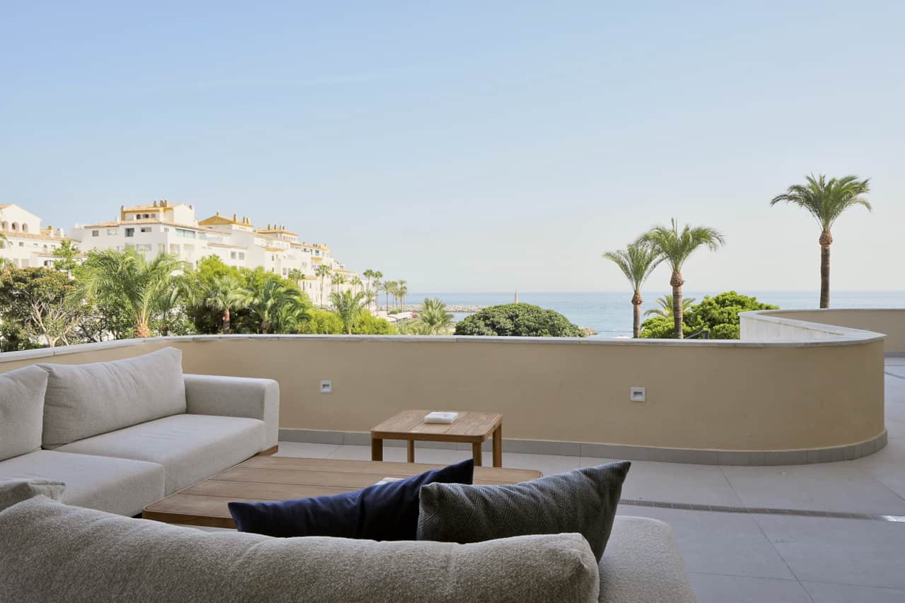 Curved terrace overlooking Puerto Banús and the sea