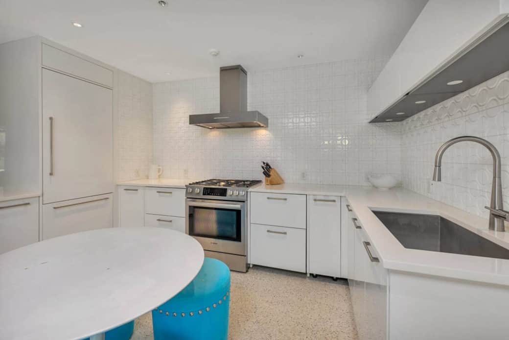 This fully renovated kitchen features top of the line appliances and is bright and cheerful. With a custom fridge, freezer, dishwasher and more, it is beautifully designed. The table and stools will be replaced with a portable island in the future. 