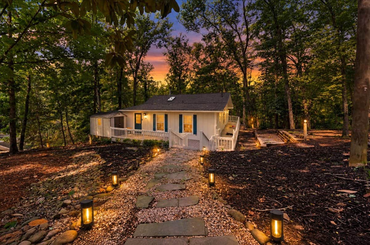 Follow the charming, lighted stone pathway to your peaceful woodland retreat on the water. 