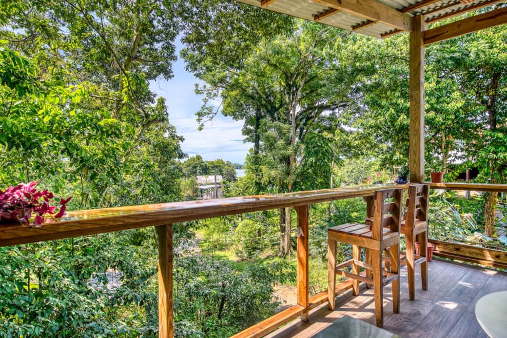 Sip your morning coffee above the jungle canopy — your elevated terrace offers glimpses of the Caribbean Sea in this Bocas del Toro tropical treehouse island getaway.
