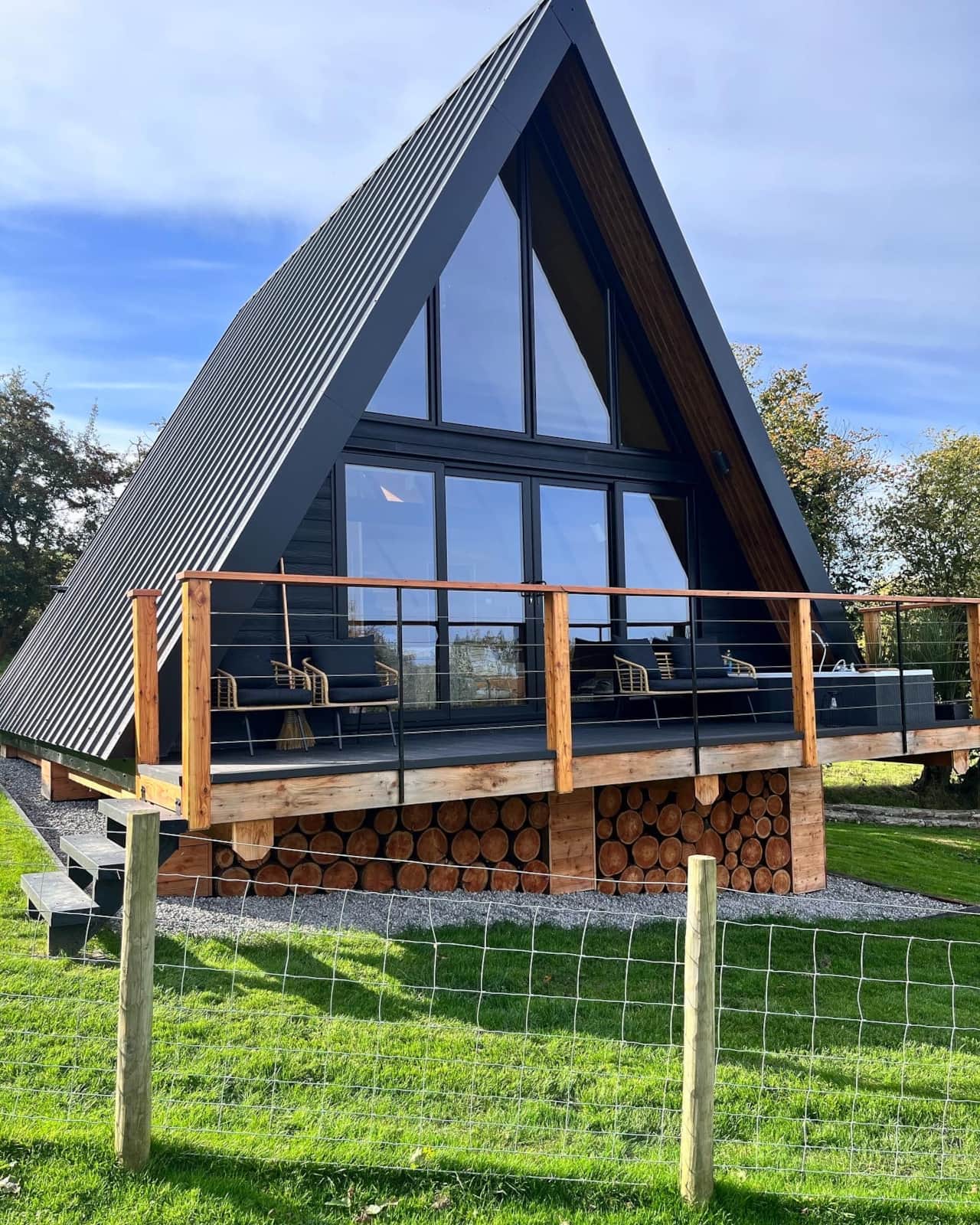 Sigrid Lodge exterior with green surroundings and wooden deck.