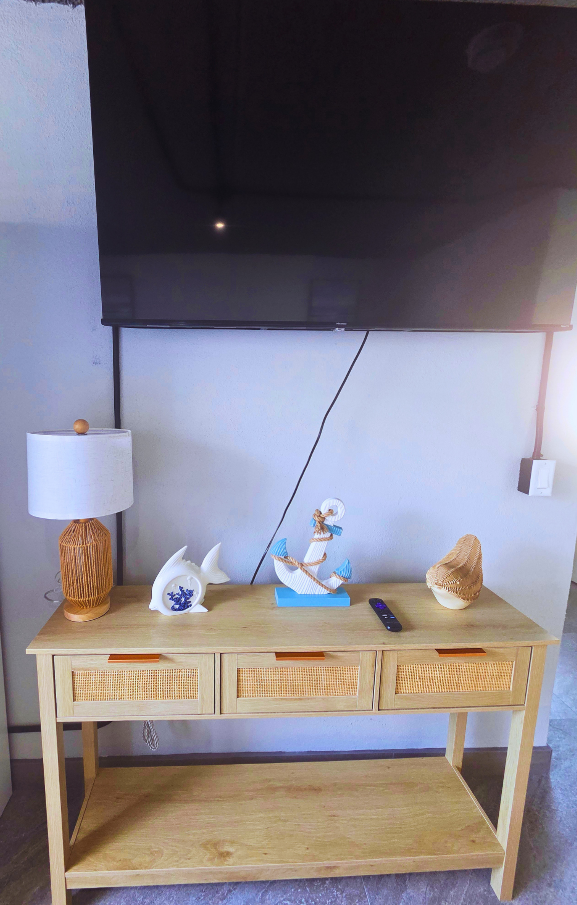 Beach-inspired coffee table with anchors, fish decor, and elegant lighting. Treasure Island, FL