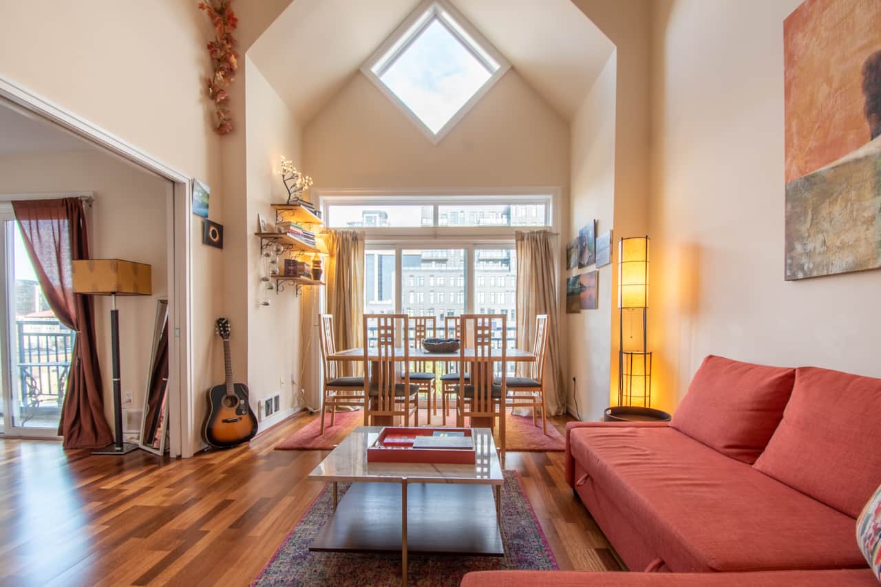 Spacious living room with sleeper sofa, flat screen smart TV, fireplace and dining table.