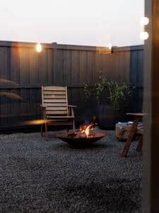 Protected yard to sit or soak the warmth of a bath or fire.   