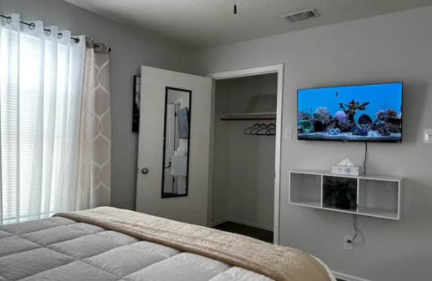 TV in bedroom with the queen bed