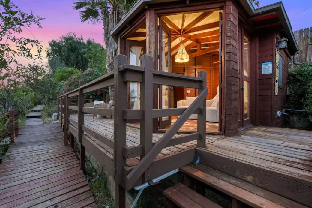 Wooden pathway with steps leading to the home’s private deck entrance. Wooden pathway with steps leading to the home’s private deck entrance.