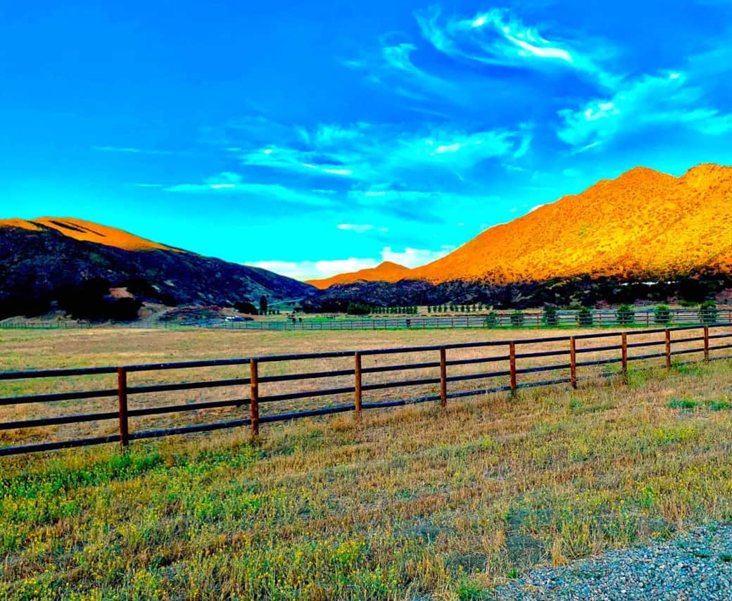 A beautiful wooden fence surrounds the front of the property enclosing 30 acres of grassland for the Cows to graze. A beautiful wooden fence surrounds the front of the property enclosing 30 acres of grassland for the Cows to graze.