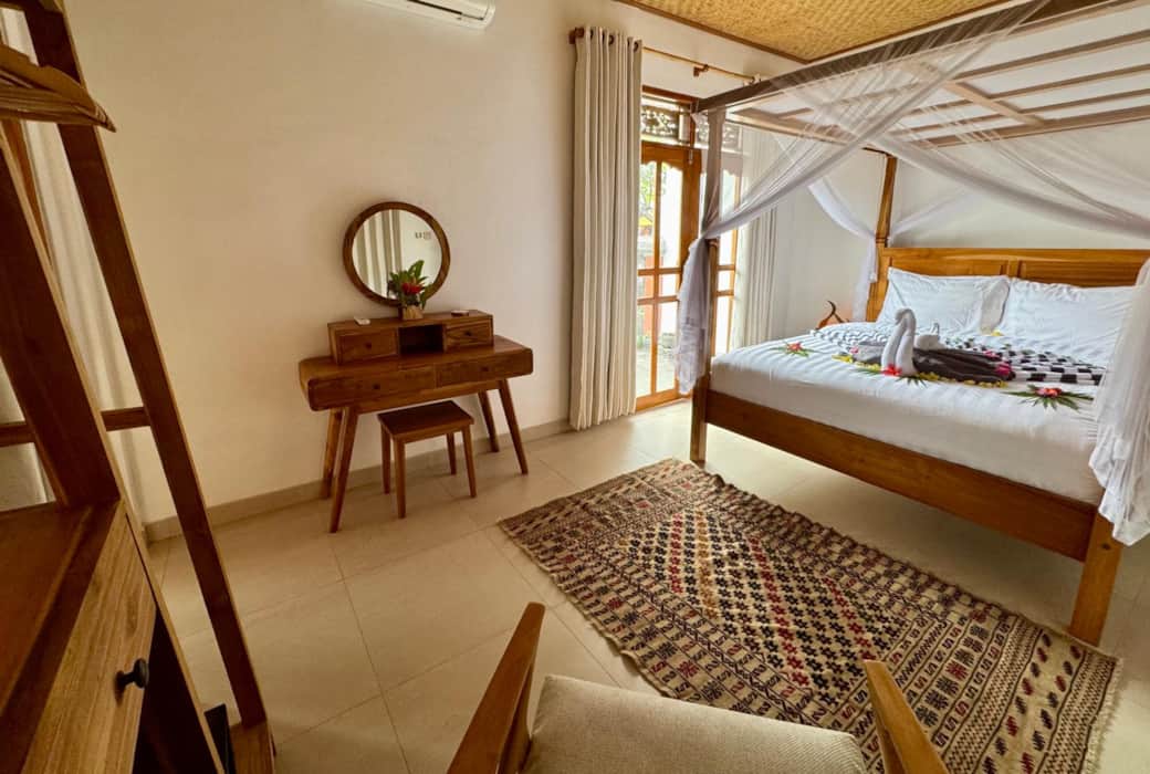 Bedroom 1 with access to the private gardens and pool terrace