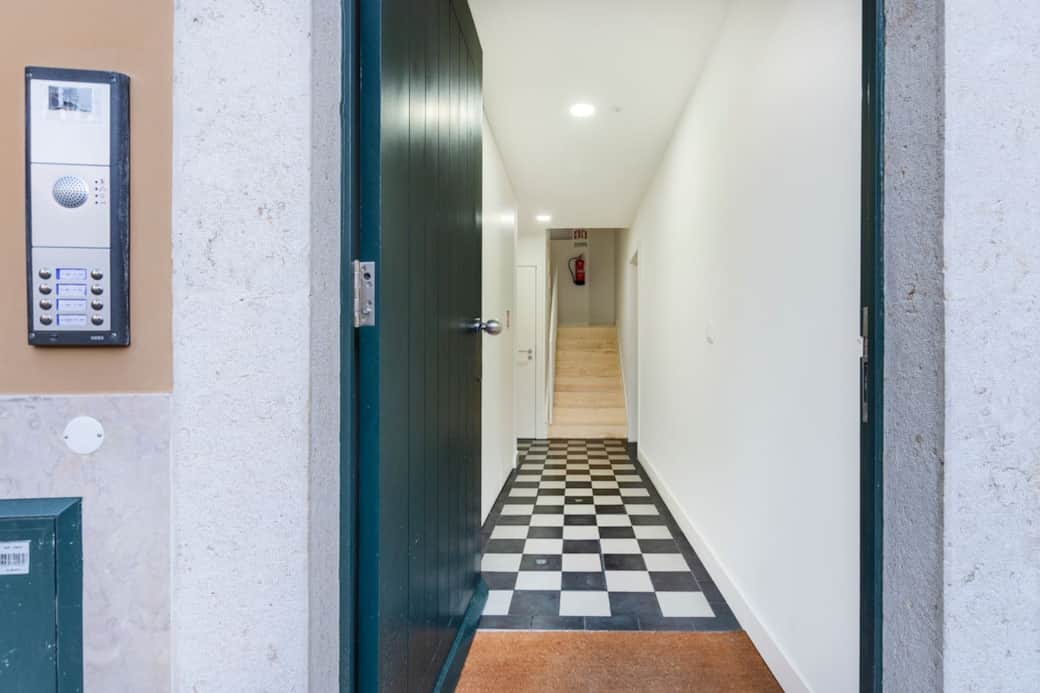 Entrance corridor to the building. Black and white tiles are handmade by Artevida handmade tile studio in Alentejo