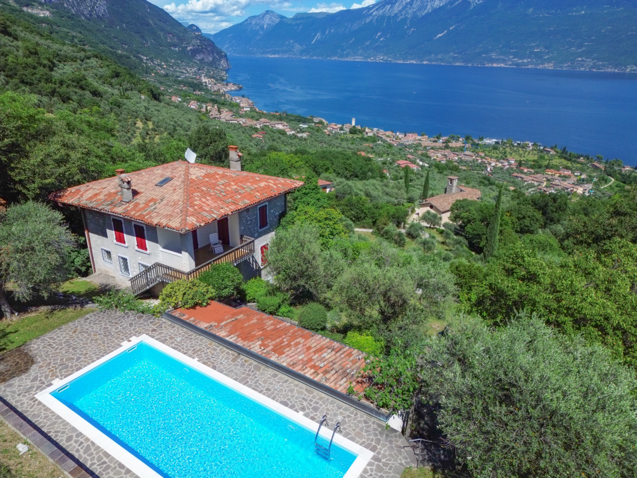 Villa Supina with private pool, garden, and panoramic lake view in the hills of Brescia's Garda area.