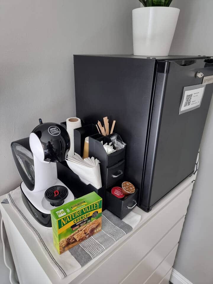 Dolce gusto Coffee machine with pods provided, a fridge and some breakfast cookies to have with your coffee.